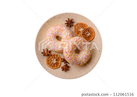 Delicious sweet bright donuts with cream on a plain background Delicious sweet bright donuts with cream on a plain background 112061516