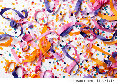Colorful streamers and confetti scattered over a surface, suggesting a celebration or party atmosphere. 112061517