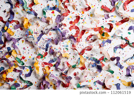Colorful streamers and confetti scattered over a surface, suggesting a celebration or party atmosphere. Colorful streamers and confetti scattered over a surface, suggesting a celebration or party atmosphere. 112061519