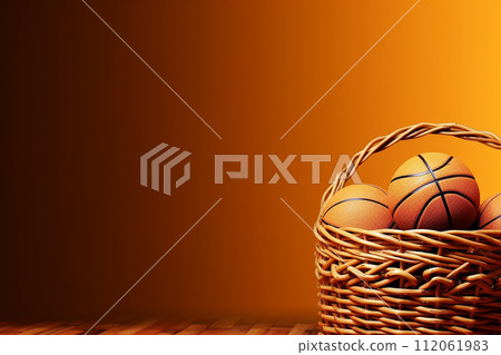 Basketballs in a Wicker Basket on orange Background 112061983