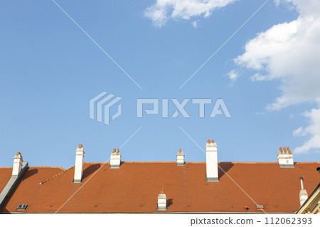 Chimneys on the roof of the house against the sky Chimneys on the roof of the house against the sky 112062393