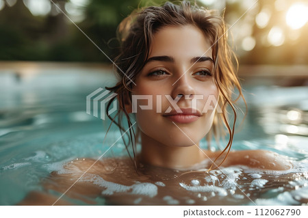 Serenity Oasis: Young Woman Basks in Outdoor Spa Pool Beauty Serenity Oasis: Young Woman Basks in Outdoor Spa Pool Beauty 112062790