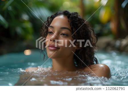 Serenity Oasis: Young Woman Basks in Outdoor Spa Pool Beauty Serenity Oasis: Young Woman Basks in Outdoor Spa Pool Beauty 112062791