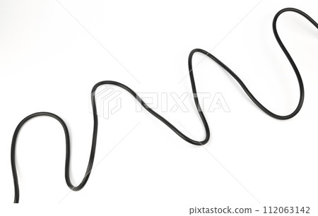 Copper wire in black insulation on a white background. Power cable. Copper wire in black insulation on a white background. Power cable. 112063142