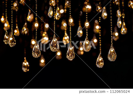 AI-generated content. Crystal Beads Dangling with Golden Light Reflections 112065024