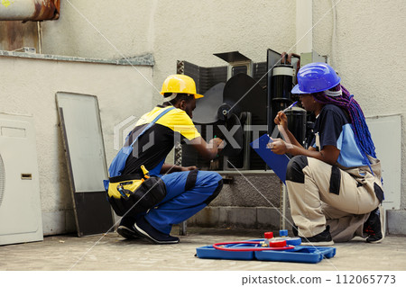 Experts commissioned for condenser routine cleaning, using dusting brush to clean dirty, clogged air filter restricting airflow, decreasing efficiency and reducing unit ability to cool air effectively 112065773