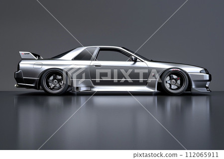 A sleek silver car with shiny alloy wheels parked on a gray surface 112065911