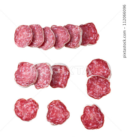 Slices of delicious spanish sausage fuet  isolated on a white background, top view. 112066096