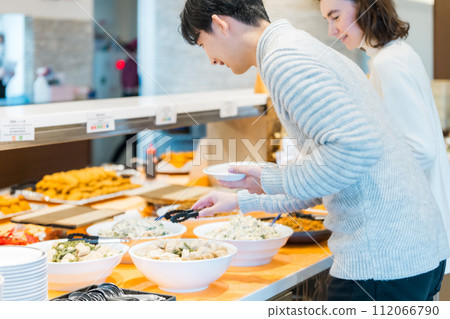 夫婦在自助餐廳選擇食物 112066790