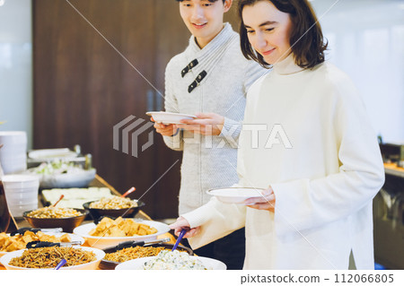 Couple choosing food at a buffet style restaurant 112066805