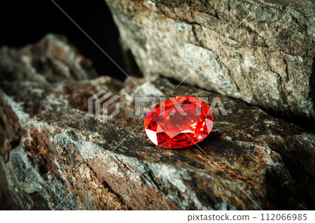 Red Ruby gemstone on stone background, close up shot 112066985