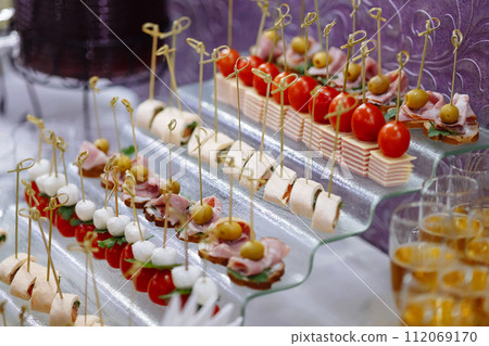 Assorted Gourmet Canapes on Glass Serving Tray.  112069170