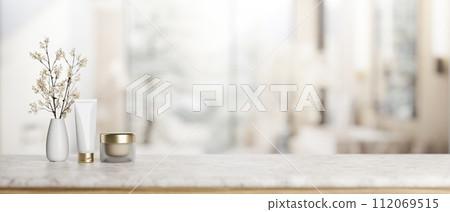 A luxury marble tabletop with a lotion tube, a facial cream, a flower vase in an elegant bathroom. A luxury marble tabletop with a lotion tube, a facial cream, a flower vase in an elegant bathroom. 112069515