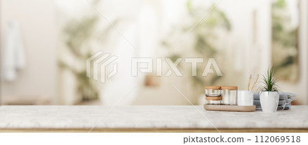 A presentation space for display product on a white marble tabletop in a modern, luxurious bathroom. A presentation space for display product on a white marble tabletop in a modern, luxurious bathroom. 112069518