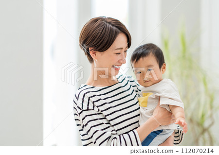 A mother holding a baby. A mother holding a baby. 112070214