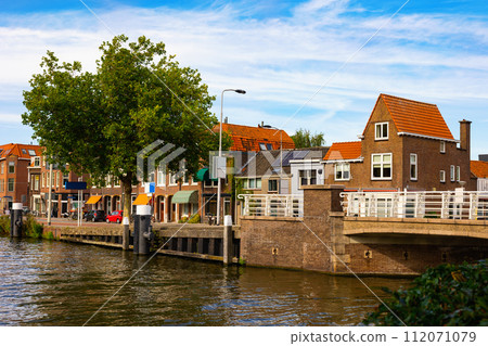 Streets along canal of Delft, Netherlands 112071079