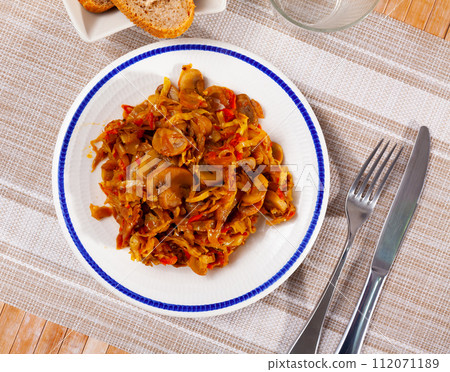 Stewed cabbage with mushrooms served on platter 112071189