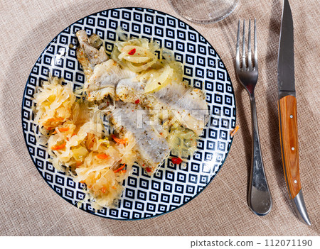 Sliced herring served with sauerkraut 112071190
