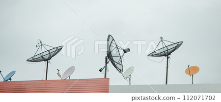 Many old communication satellite dishes expired and left on rooftops. Many old communication satellite dishes expired and left on rooftops. 112071702