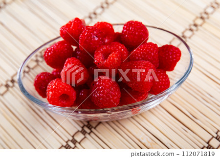 Juicy fresh raspberries served to table 112071819