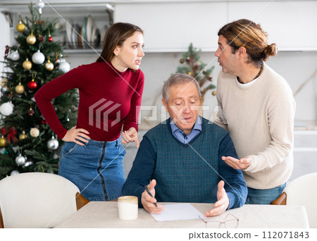 Adult children argue with each other and show their mature father how to fill out documents correctly Adult children argue with each other and show their mature father how to fill out documents correctly 112071843