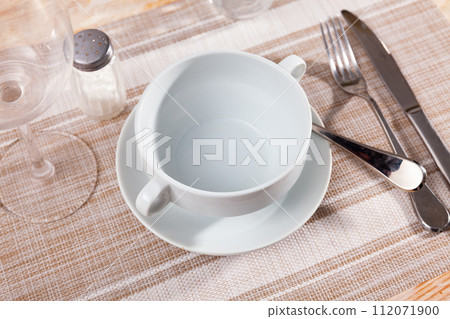 Bowl served on table with cutlery 112071900