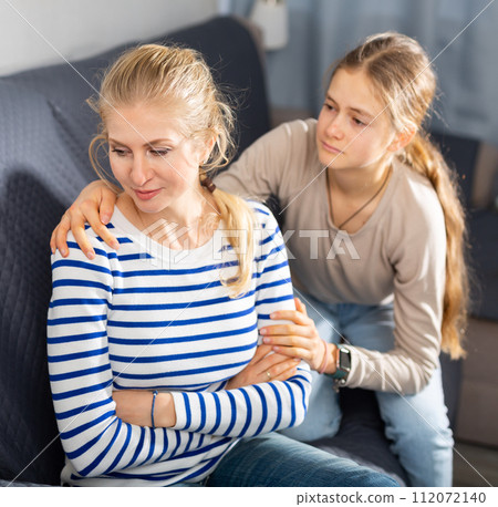 Upset woman sitting on sofa after quarrel 112072140