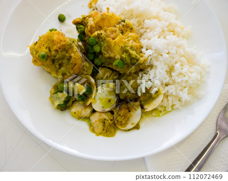 Dish from chef - stewed large piece of monkfish, garnished with boiled rice, quail eggs, green peas Dish from chef - stewed large piece of monkfish, garnished with boiled rice, quail eggs, green peas 112072469