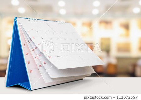 desk calendar on table with blurred bokeh background appointment and business meeting concept 112072557