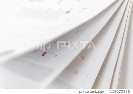 Calendar page flipping sheet close up blur background business schedule planning appointment meeting concept Calendar page flipping sheet close up blur background business schedule planning appointment meeting concept 112072856