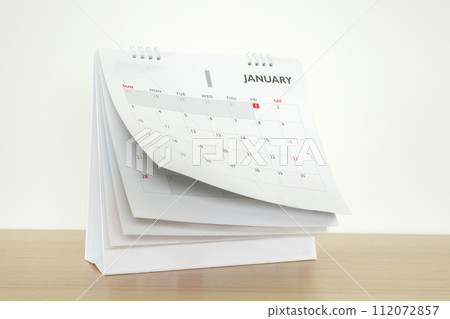 Calendar page flipping sheet on wood table background business schedule planning appointment meeting concept Calendar page flipping sheet on wood table background business schedule planning appointment meeting concept 112072857
