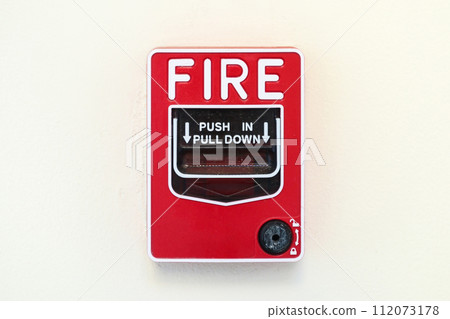Fire alarm switch on white wall background 112073178