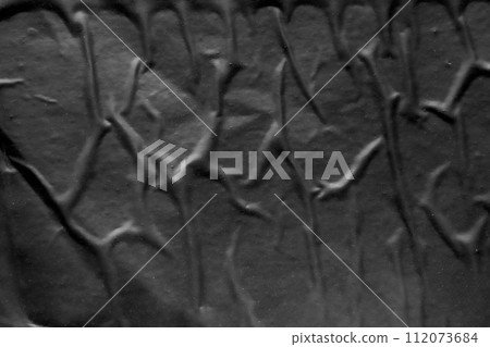 black crumpled and creased plastic poster texture background 112073684