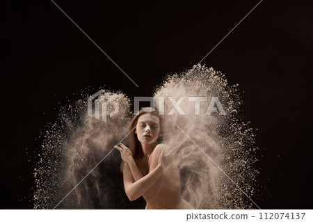 Calm dreamy woman in underwear with wings of sand behind her back 112074137