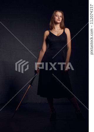 Stylish woman in black dress with katana Stylish woman in black dress with katana 112074157