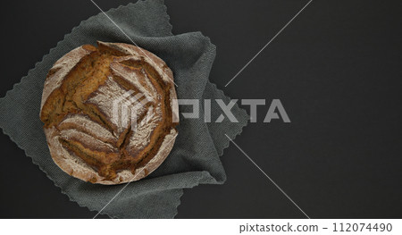 Bread loaf on a gray kitchen towel black chalkboard 112074490