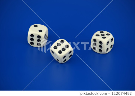 Gaming scene with three dice on blue background Gaming scene with three dice on blue background 112074492