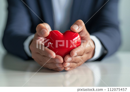 businessman with heart model health insurance symbol bokeh style background with generative ai 112075457