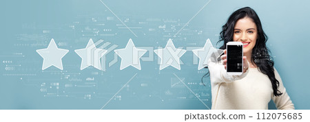 Rating star concept with woman holding a smartphone 112075685