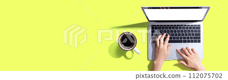 Person using a laptop computer 112075702