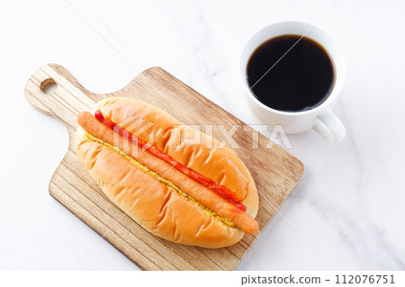 Lunch time with chorizo sausage bread (hot dog) with mustard and ketchup and coffee 112076751