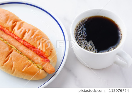 Lunch time with chorizo sausage bread (hot dog) with mustard and ketchup and coffee Lunch time with chorizo sausage bread (hot dog) with mustard and ketchup and coffee 112076754