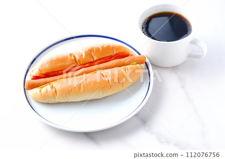 Lunch time with chorizo sausage bread (hot dog) with mustard and ketchup and coffee 112076756
