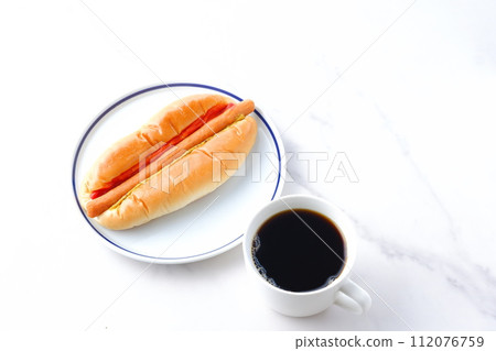 Lunch time with chorizo sausage bread (hot dog) with mustard and ketchup and coffee 112076759