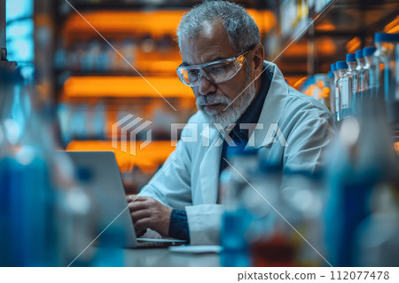 Scientist using laptop for genetic research in laboratory. 112077478