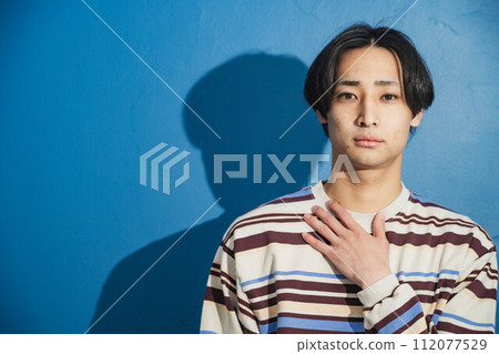 Stylish young man with blue background Stylish young man with blue background 112077529