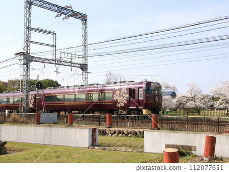 Kintetsu's sightseeing express Aoyoshi runs through the cherry blossom trees inside the World Heritage site of Nara Taira Castle. 112077651