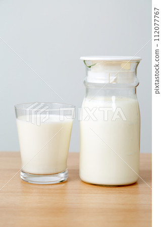 glass milk pot and glass of milk glass milk pot and glass of milk 112077767