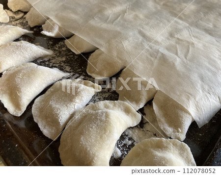 Dumplings made from dough with potato filling 112078052