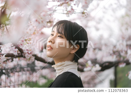 Side view japanese woman closing eye with sakura flower tree in Tokyo city japan spring season Side view japanese woman closing eye with sakura flower tree in Tokyo city japan spring season 112078363